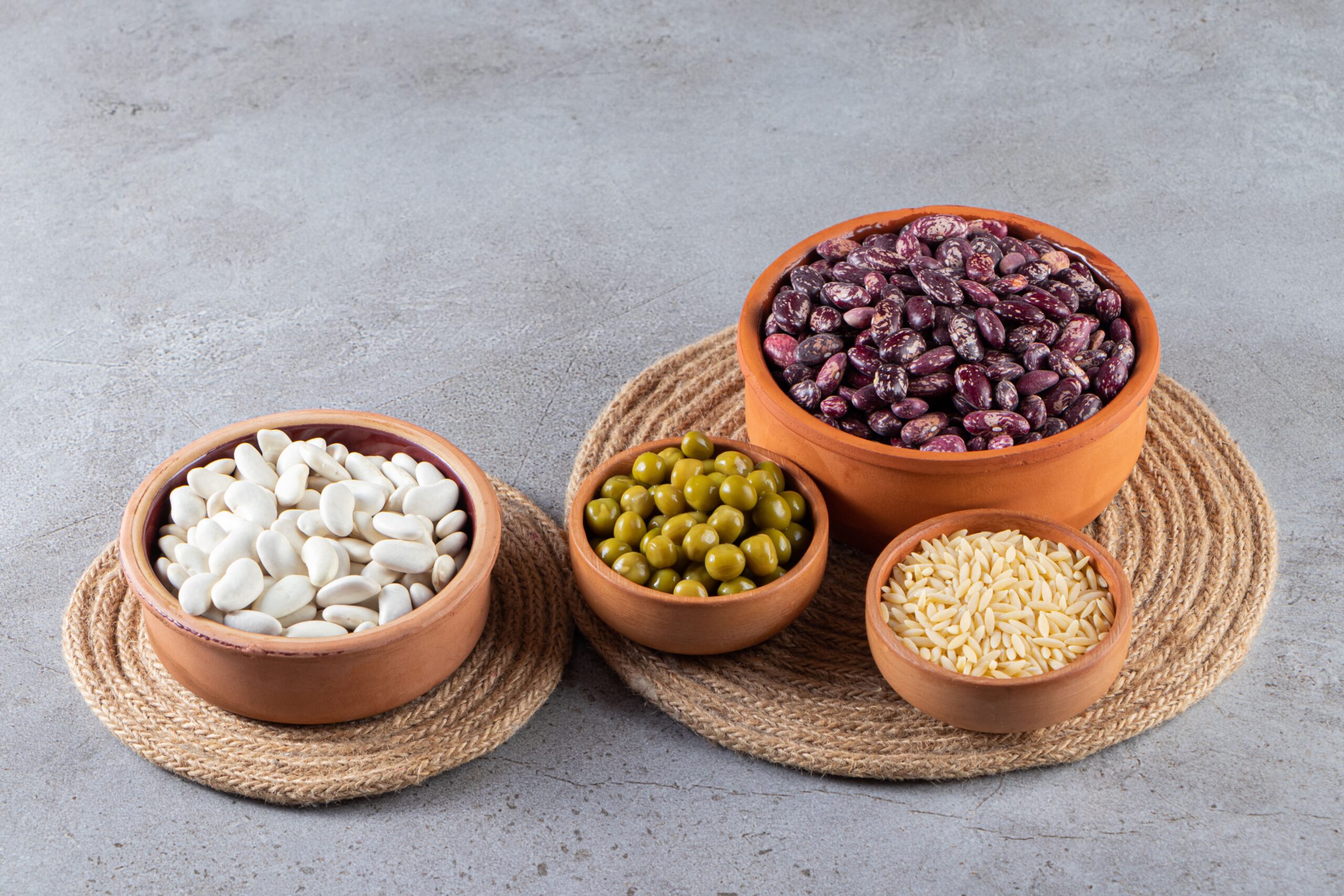 pile-uncooked-lentils-beans-rice-stone-background-min